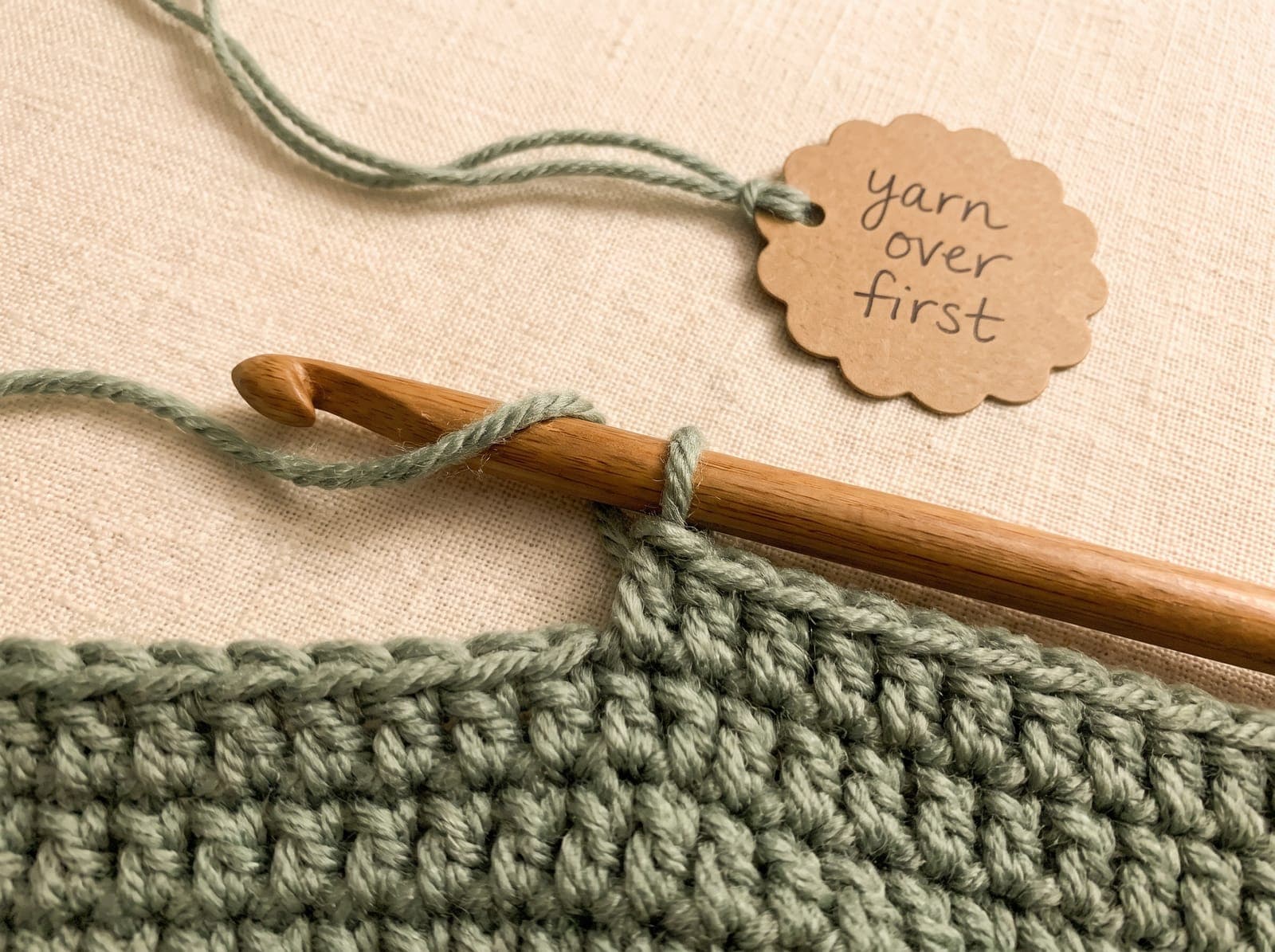 A yarn over on the hook before inserting into the stitch, the first step of half double crochet.