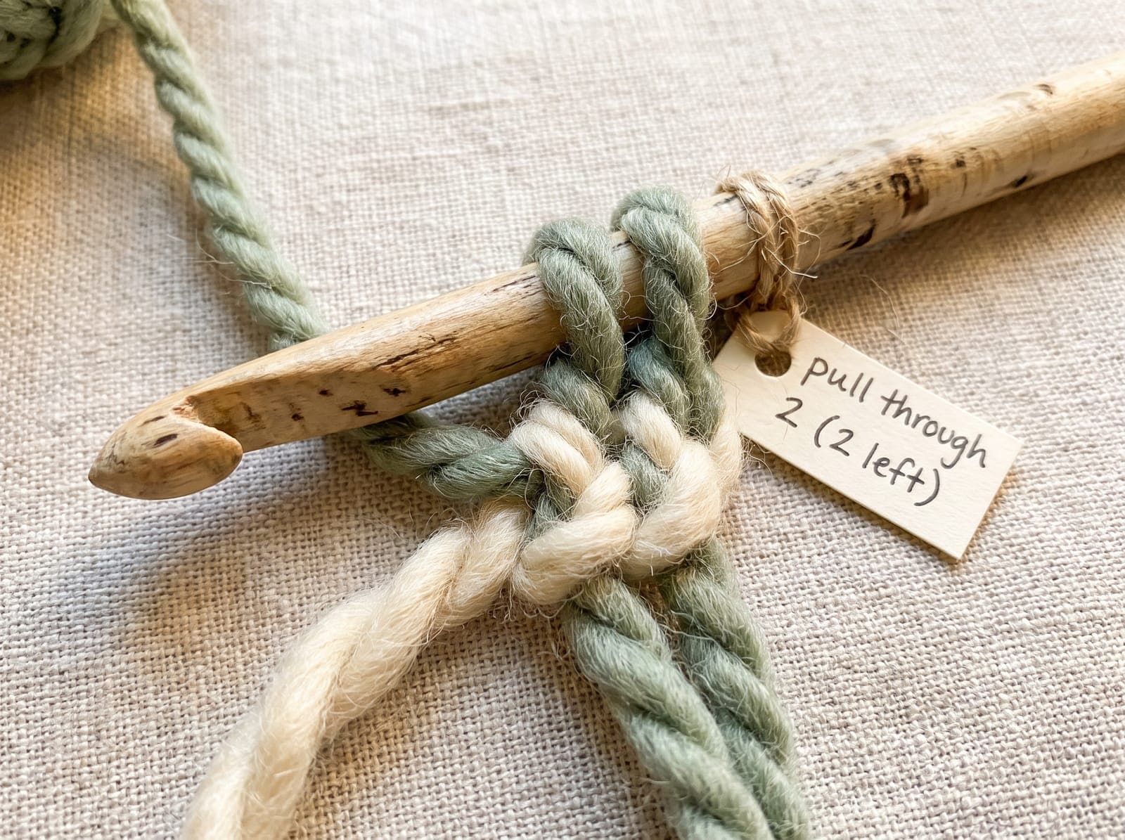 Pulling through two more loops of treble crochet, leaving two loops on the hook.